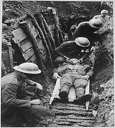 Picture of an injured World War I soldier receiving first aid.